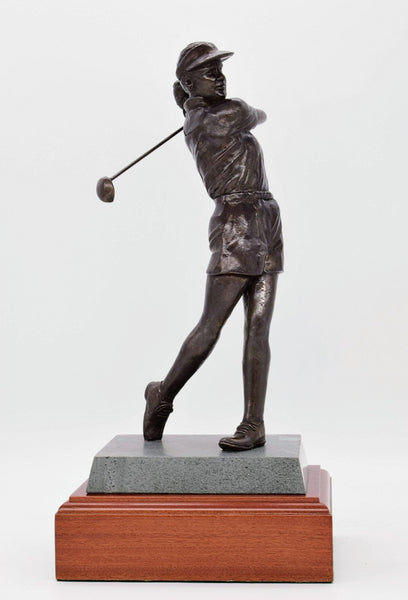 Lady golfer trophy in patinated Bronze. This exclusive patinated bronze figure is an outstanding work of sporting art and deserves the warm commendation it gets from every recipient. With a twin stone and mahogany base, and would be perfect as a perpetual trophy.  They do not come better than this for power and purpose. A modern confident lady prepared to take on anyone on any course, this piece shows a beautifully balanced completion of the stroke