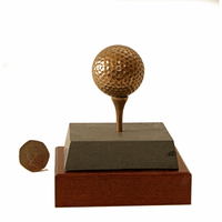 This actual-sized bronze golf ball is the smallest of three bronze golf ball trophies available from Thomas & Peters. Mounted on a double base of slate and mahogany, both ball and tee are exact facsimilies of the real thing.